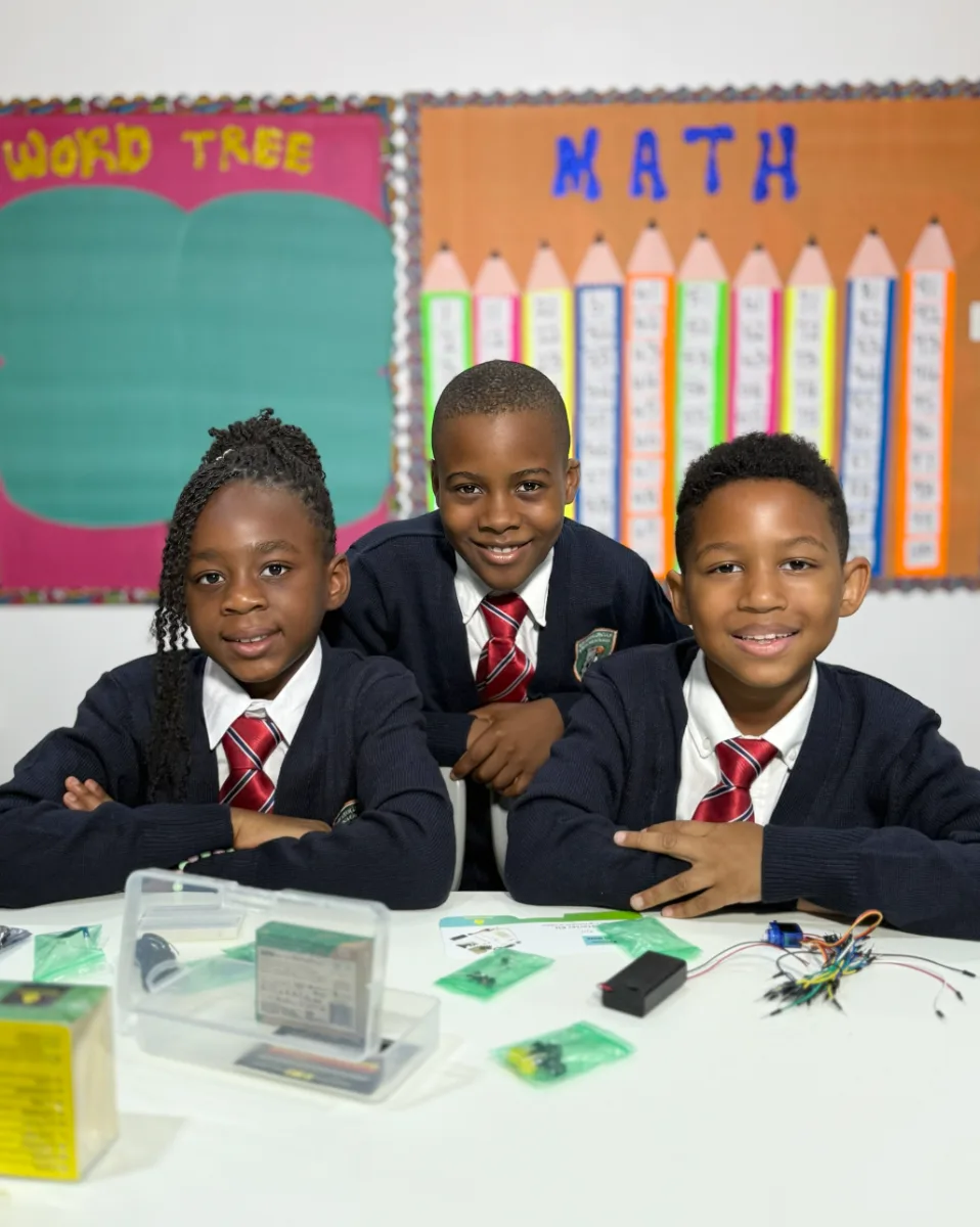 Middle School students working with an electronics kit.
