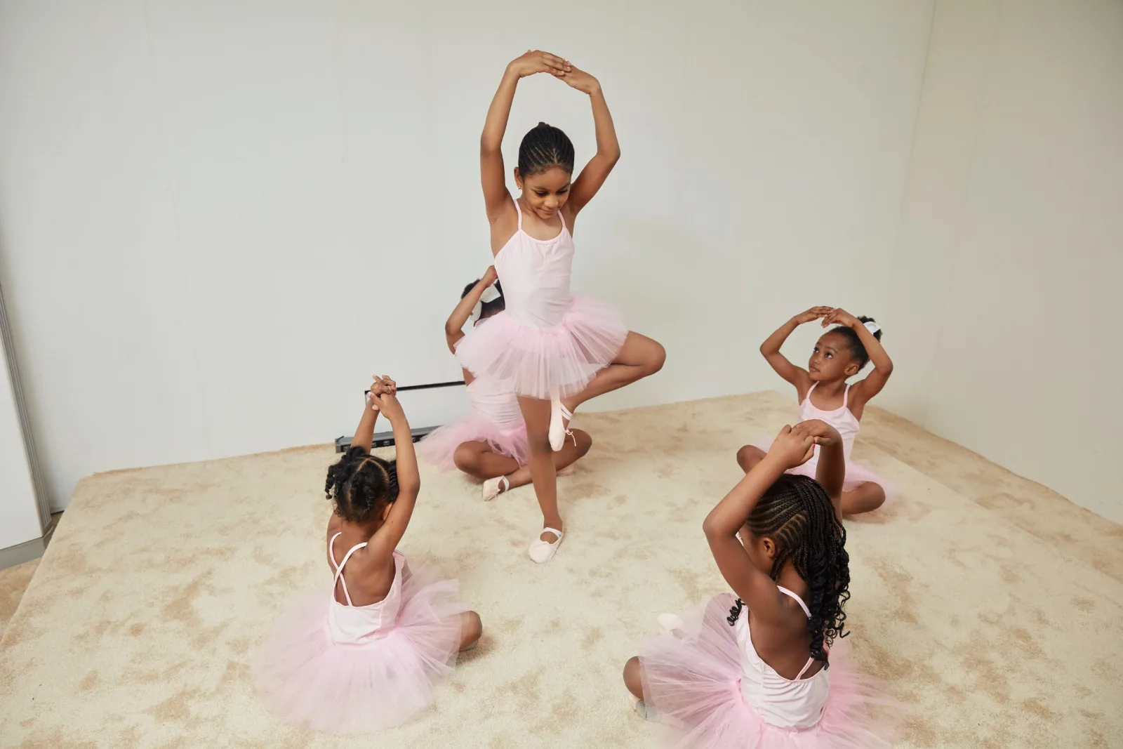 Students stretching during a ballet class.